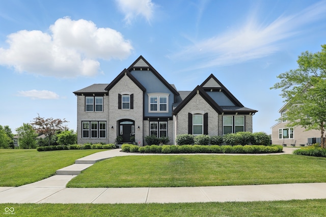 2485 Alexandra Dr, Carmel, IN 46074 - view of front of house featuring a front yard, central air condition unit, and brick siding