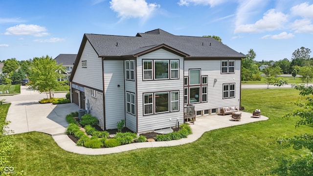 2485 Alexandra Dr, Carmel, IN 46074 - back of house featuring an outdoor living space, a lawn, driveway, an attached garage, and a patio area