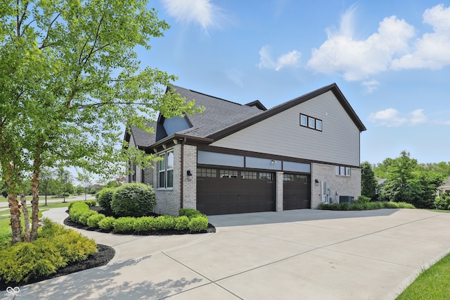 2485 Alexandra Dr, Carmel, IN 46074 - view of side of property with brick siding, driveway, roof with shingles, central AC unit, and an attached garage