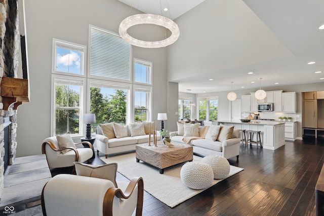 2485 Alexandra Dr, Carmel, IN 46074 - living room with a towering ceiling, dark wood finished floors, recessed lighting, and a stone fireplace