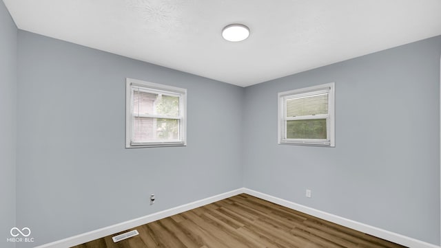 3106 N Harding St, Indianapolis, IN 46208 - empty room featuring wood finished floors and baseboards