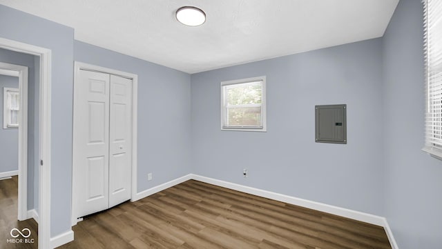 3106 N Harding St, Indianapolis, IN 46208 - unfurnished bedroom featuring electric panel, wood finished floors, baseboards, and a closet