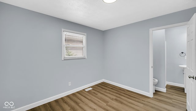 3106 N Harding St, Indianapolis, IN 46208 - unfurnished bedroom featuring wood finished floors and baseboards