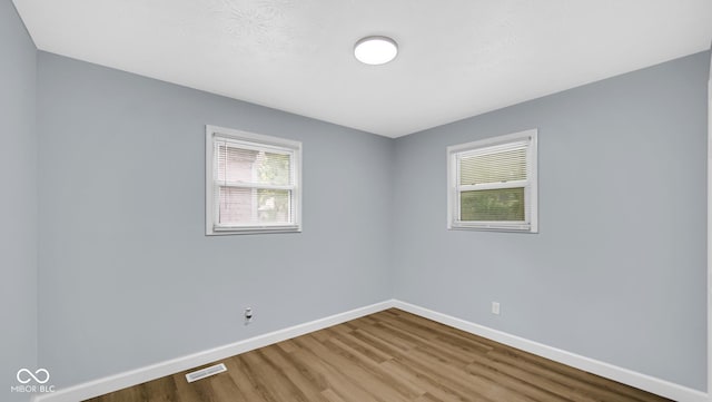 3106 N Harding St, Indianapolis, IN 46208 - empty room featuring wood finished floors and baseboards