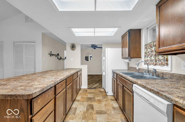 8102 Sycamore Springs Trl, Indianapolis, IN 46239 - kitchen featuring white appliances, a sink, stone finish floors, a ceiling fan, and a skylight