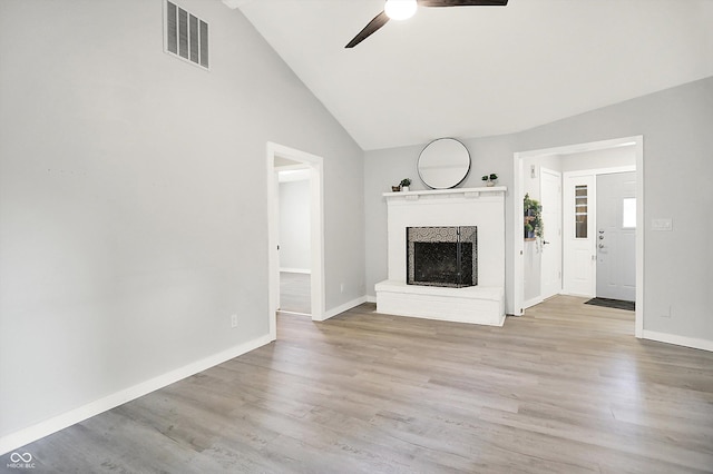 9002 Walton St, Indianapolis, IN 46231 - unfurnished living room with a ceiling fan, vaulted ceiling, a brick fireplace, wood finished floors, and baseboards