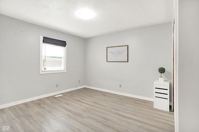 9002 Walton St, Indianapolis, IN 46231 - spare room with light wood-type flooring, baseboards, and a textured ceiling