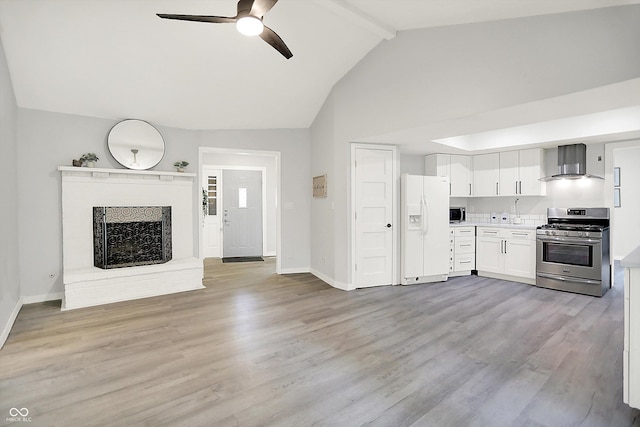 9002 Walton St, Indianapolis, IN 46231 - kitchen with stainless steel appliances, wall chimney range hood, ceiling fan, light countertops, and white cabinetry
