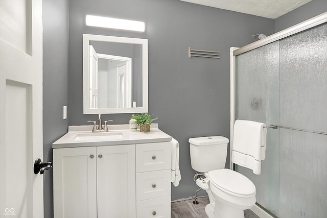 9002 Walton St, Indianapolis, IN 46231 - full bath with a stall shower, vanity, toilet, and wood finished floors