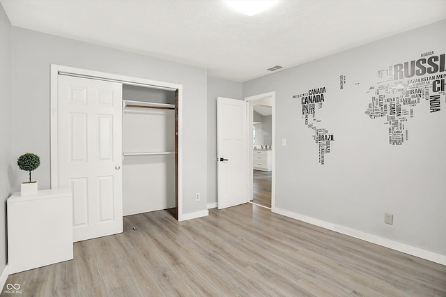 9002 Walton St, Indianapolis, IN 46231 - unfurnished bedroom with light wood-style floors, a closet, and baseboards