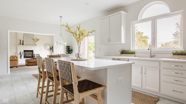 734 Richland Way, Westfield, IN 46074 - kitchen with a sink, a breakfast bar, a center island, light countertops, and white cabinetry