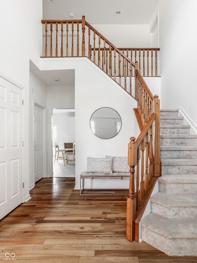 734 Richland Way, Westfield, IN 46074 - stairs featuring a towering ceiling, wood finished floors, and baseboards