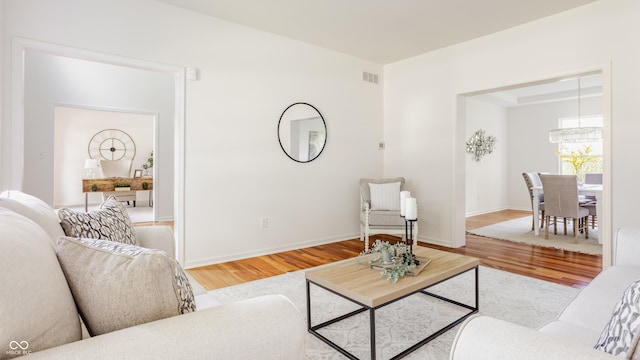734 Richland Way, Westfield, IN 46074 - living room featuring wood finished floors, a chandelier, and baseboards