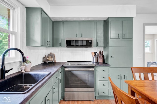 225 E Norris Hts, North Vernon, IN 47265 - kitchen featuring appliances with stainless steel finishes, green cabinets, a sink, and backsplash