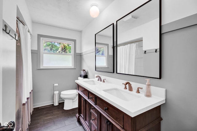 225 E Norris Hts, North Vernon, IN 47265 - full bath featuring double vanity, toilet, a shower with shower curtain, wood finished floors, and baseboards