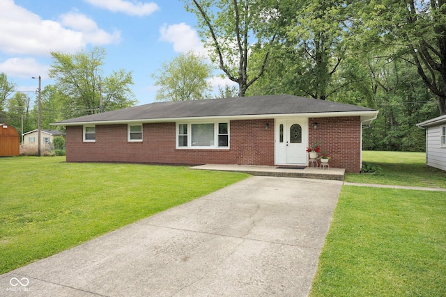 225 E Norris Hts, North Vernon, IN 47265 - ranch-style house with brick siding, a front yard, and concrete driveway