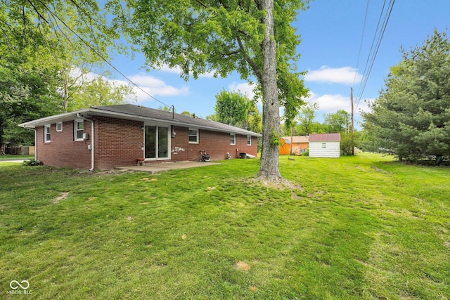225 E Norris Hts, North Vernon, IN 47265 - rear view of house featuring a patio area, brick siding, and a lawn
