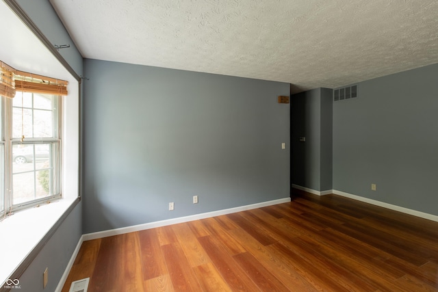 1708 Mason Dixon Dr S, West Lafayette, IN 47906 - empty room with wood finished floors, a textured ceiling, and baseboards