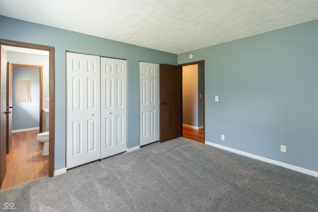 1708 Mason Dixon Dr S, West Lafayette, IN 47906 - unfurnished bedroom featuring multiple closets, baseboards, carpet, and a textured ceiling