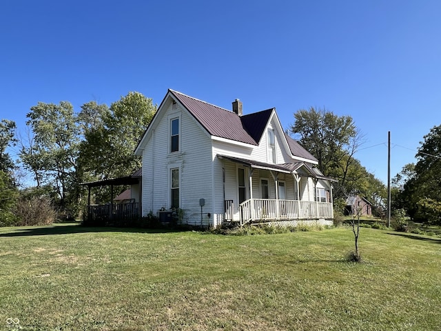 5855 S County Road 800 E, Coatesville, IN 46121 - view of home's exterior featuring a porch, a yard, metal roof, and a chimney