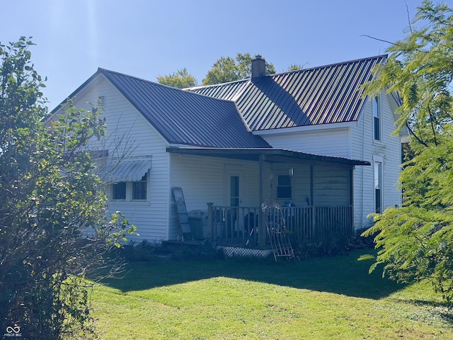 5855 S County Road 800 E, Coatesville, IN 46121 - back of property featuring a chimney, a lawn, metal roof, and a porch