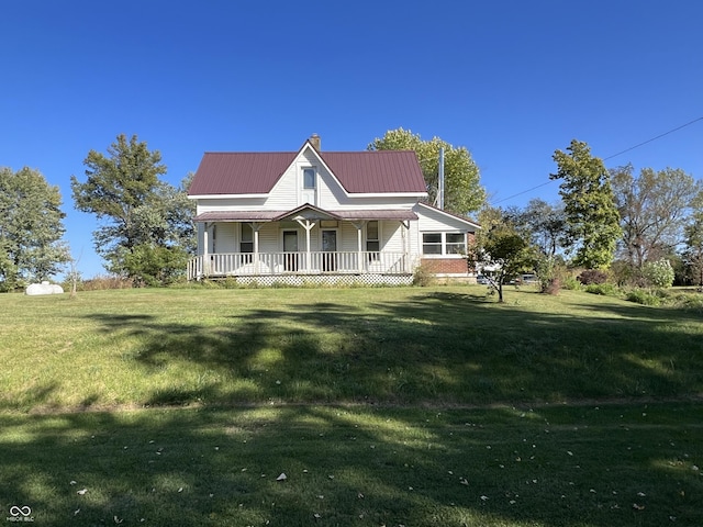 5855 S County Road 800 E, Coatesville, IN 46121 - farmhouse-style home featuring a porch, a front yard, a chimney, and metal roof