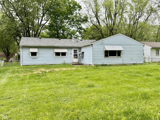 3325 Canaday Dr, Anderson, IN 46013 - rear view of house featuring a yard and roof with shingles