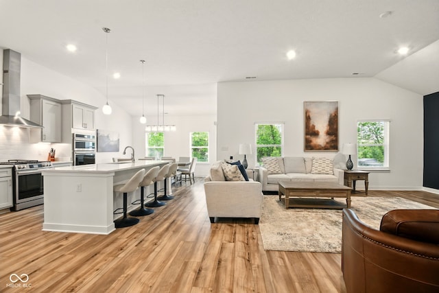 19257 Red Willow Ln, Noblesville, IN 46062 - living room featuring lofted ceiling, light wood-style flooring, recessed lighting, and baseboards