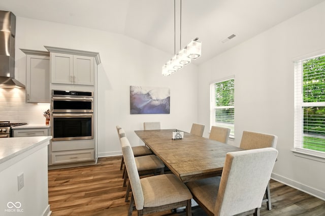 19257 Red Willow Ln, Noblesville, IN 46062 - dining space featuring dark wood-style flooring, lofted ceiling, and baseboards