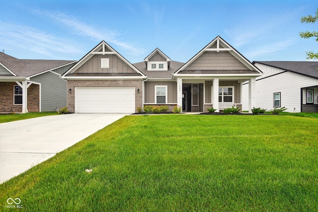 19257 Red Willow Ln, Noblesville, IN 46062 - craftsman house featuring board and batten siding, a front lawn, driveway, brick siding, and an attached garage