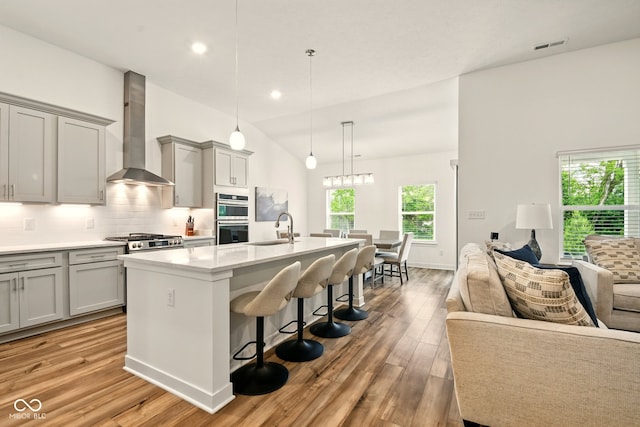 19257 Red Willow Ln, Noblesville, IN 46062 - kitchen with gray cabinetry, wall chimney exhaust hood, a sink, stainless steel double oven, and recessed lighting