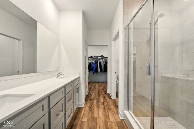 19257 Red Willow Ln, Noblesville, IN 46062 - full bath with double vanity, a shower stall, wood finished floors, and a spacious closet