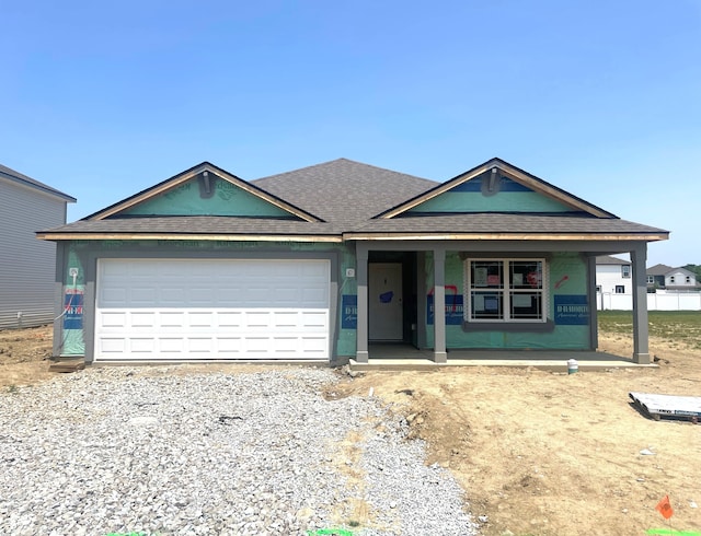 1170 Mcbride St, Greenfield, IN 46140 - property in mid-construction featuring a porch, roof with shingles, a garage, and gravel driveway