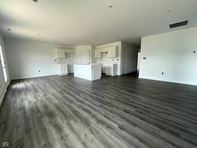 1170 Mcbride St, Greenfield, IN 46140 - unfurnished living room featuring dark wood-type flooring and baseboards
