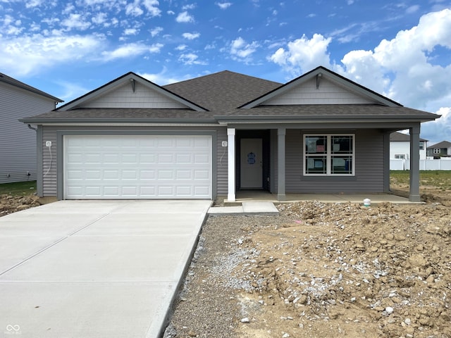 1170 Mcbride St, Greenfield, IN 46140 - view of front of property with roof with shingles, driveway, a porch, and a garage