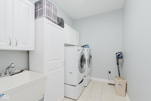 6337 Ederline Ln, Noblesville, IN 46062 - washroom with washer and dryer, cabinet space, baseboards, and light tile patterned floors