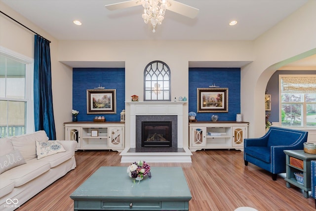 6337 Ederline Ln, Noblesville, IN 46062 - living room with arched walkways, a glass covered fireplace, ceiling fan, wood finished floors, and recessed lighting