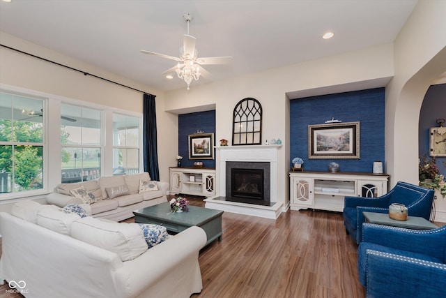 6337 Ederline Ln, Noblesville, IN 46062 - living room with ceiling fan, a glass covered fireplace, wood finished floors, recessed lighting, and arched walkways