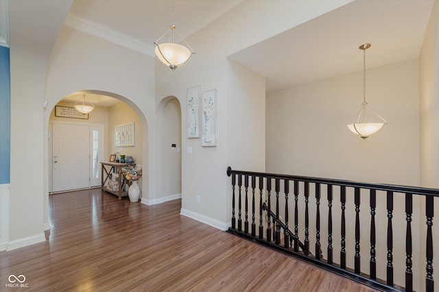 6337 Ederline Ln, Noblesville, IN 46062 - hallway with wood finished floors, arched walkways, baseboards, and an upstairs landing