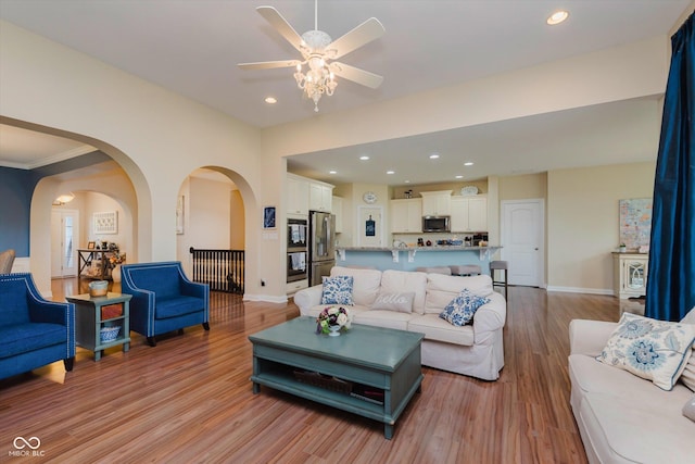 6337 Ederline Ln, Noblesville, IN 46062 - living room featuring light wood-style floors, a ceiling fan, baseboards, recessed lighting, and arched walkways