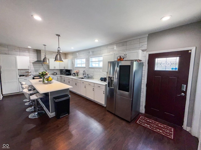 201 N Tacoma Ave, Indianapolis, IN 46201 - kitchen featuring appliances with stainless steel finishes, wall chimney exhaust hood, dark wood finished floors, white cabinets, and light countertops