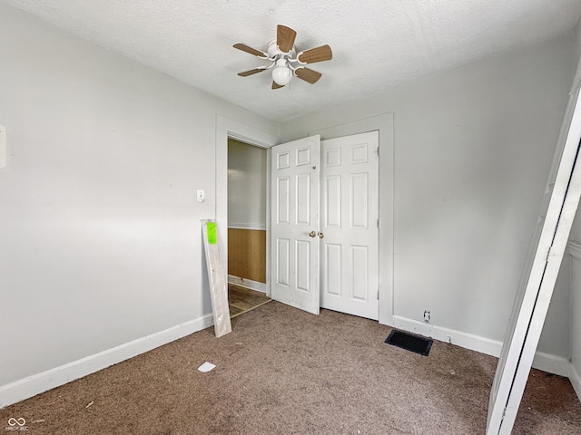 145 S 7th Ave, Beech Grove, IN 46107 - unfurnished bedroom with carpet floors, baseboards, a textured ceiling, a closet, and ceiling fan