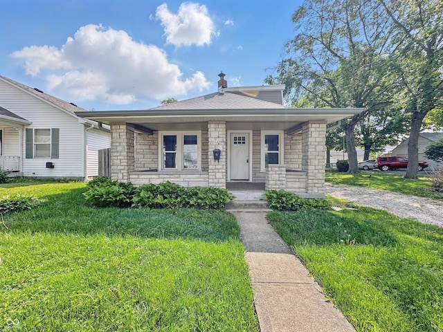 145 S 7th Ave, Beech Grove, IN 46107 - bungalow-style house with stone siding, a porch, and a front lawn