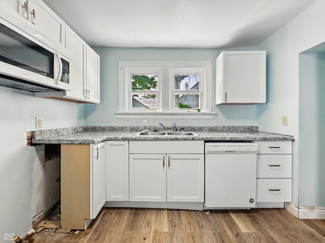 145 S 7th Ave, Beech Grove, IN 46107 - kitchen featuring white appliances, a sink, white cabinets, and wood finished floors