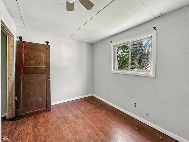 145 S 7th Ave, Beech Grove, IN 46107 - unfurnished bedroom with wood finished floors, baseboards, and a ceiling fan