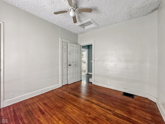 145 S 7th Ave, Beech Grove, IN 46107 - unfurnished bedroom featuring attic access, baseboards, a textured ceiling, wood finished floors, and ceiling fan