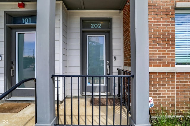 727 N Illinois St Unit 202, Indianapolis, IN 46204 - property entrance with brick siding and covered porch