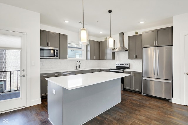 727 N Illinois St Unit 202, Indianapolis, IN 46204 - kitchen featuring appliances with stainless steel finishes, wall chimney exhaust hood, dark wood finished floors, decorative backsplash, and a center island