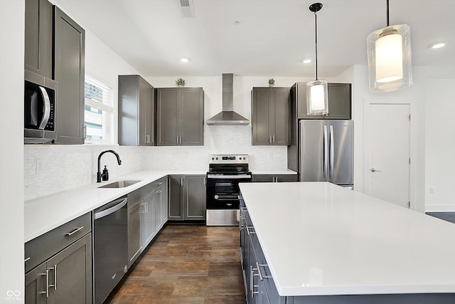 727 N Illinois St Unit 202, Indianapolis, IN 46204 - kitchen featuring wall chimney range hood, stainless steel appliances, a sink, a kitchen island, and backsplash