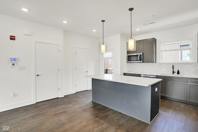 727 N Illinois St Unit 202, Indianapolis, IN 46204 - kitchen with stainless steel appliances, a sink, healthy amount of natural light, dark wood finished floors, and recessed lighting